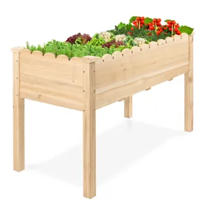 A wooden elevated garden planter filled with various vegetables and herbs.