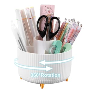 A white rotating desk organizer holds various stationery items, including markers, scissors, a ruler, cute pens, and correction tape. It features 360-degree rotation for easy access.