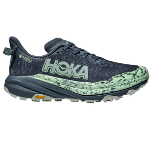 A HOKA trail running shoe featuring a GORE-TEX membrane and Vibram sole for enhanced traction and waterproofing, designed in a navy and mint green color scheme.