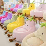 Colorful, fruit-shaped plush chairs with smiley faces are arranged in two rows, featuring various colors like pink, yellow, green, and purple. They're equipped with playful feet and leafy tops, creating a whimsical seating option for children's spaces.