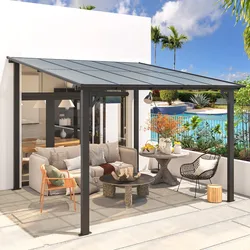 A modern outdoor patio with a metal-framed canopy, featuring seating including a sofa with pillows, a wicker chair, and a wooden armchair, surrounding a stone coffee table. A side table holds decorative vases, and a pool is visible in the background.