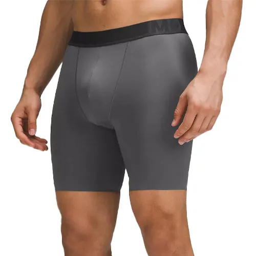 A model is wearing gray compression shorts with a black waistband.