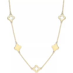 A necklace with alternating solid and open quatrefoil-shaped motifs on a gold chain.
