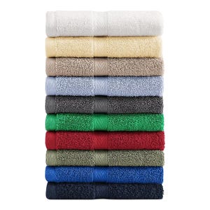 A stack of Tommy Hilfiger bath towels in a variety of colors: white, cream, beige, light blue, grey, dark grey, green, red, olive, blue, and navy.