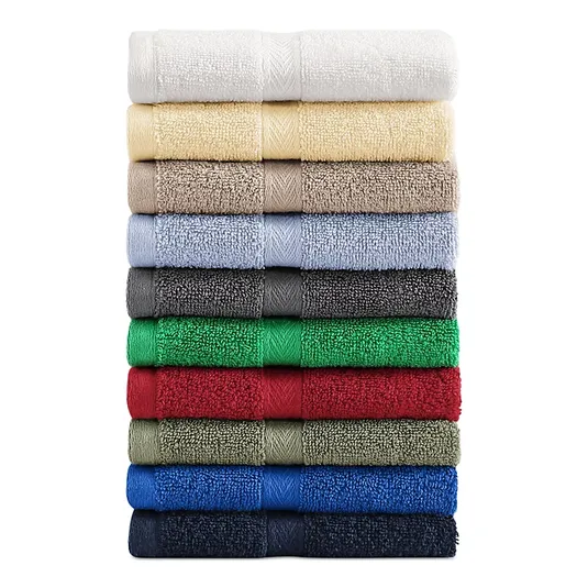 A stack of Tommy Hilfiger bath towels in a variety of colors: white, cream, beige, light blue, grey, dark grey, green, red, olive, blue, and navy.