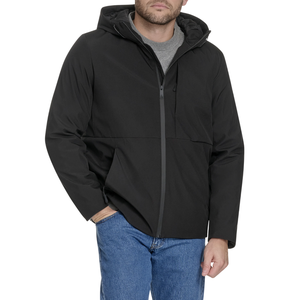 A man is wearing a black hooded jacket with a front zipper over a gray T-shirt, paired with blue jeans.