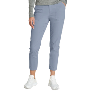 A person is wearing light blue cropped pants with patch pockets, paired with a gray long-sleeve top and white sneakers.