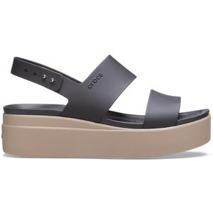 The Crocs Brooklyn Wedge Low Sandals feature a black, two-strap design with an adjustable ankle strap on a beige platform sole, offering style and comfort.