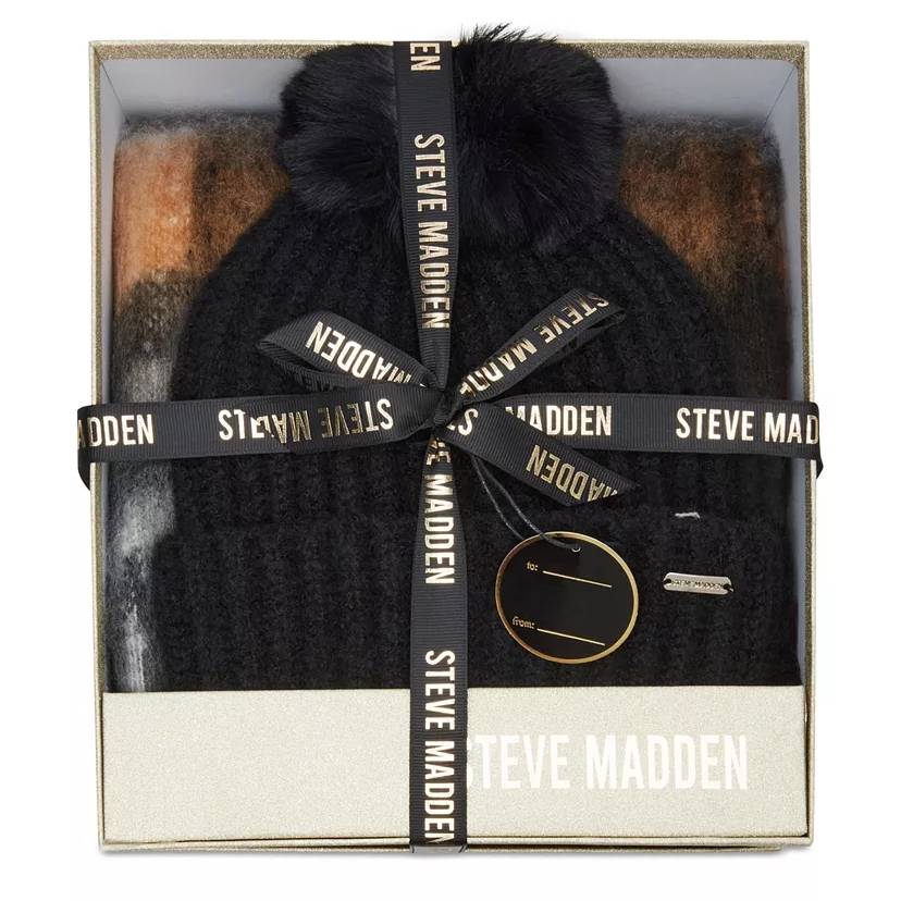 Steve Madden gift set with a black knit beanie featuring a pom-pom, wrapped in branded ribbon, and accompanied by a scarf in a box.