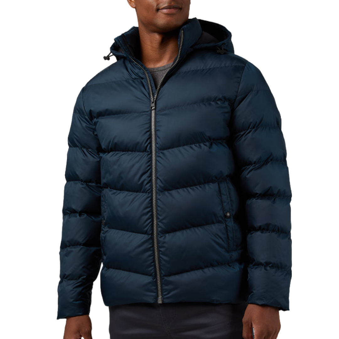 A man is wearing a navy blue, hooded puffer jacket with a front zipper, suitable for cold weather.