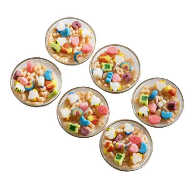 6-pack of mini soy candles shaped like cereal bowls, featuring colorful cereal-inspired designs with marshmallow-like details. Each candle has a creamy base resembling milk and multicolored cereal pieces.