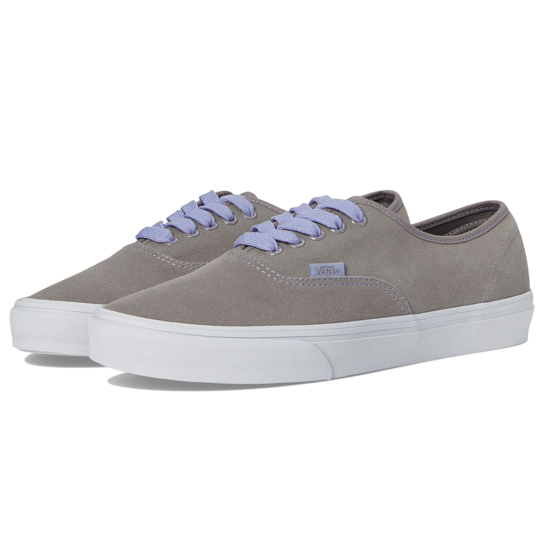 Gray Vans sneakers with lavender laces and a white rubber sole. The shoes feature a soft canvas upper with minimal stitching and a classic low-top design.