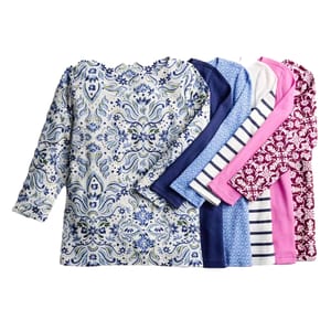 A collection of six long-sleeve shirts with various patterns and colors, including floral, stripes, and solid designs, displayed in a fanned arrangement.
