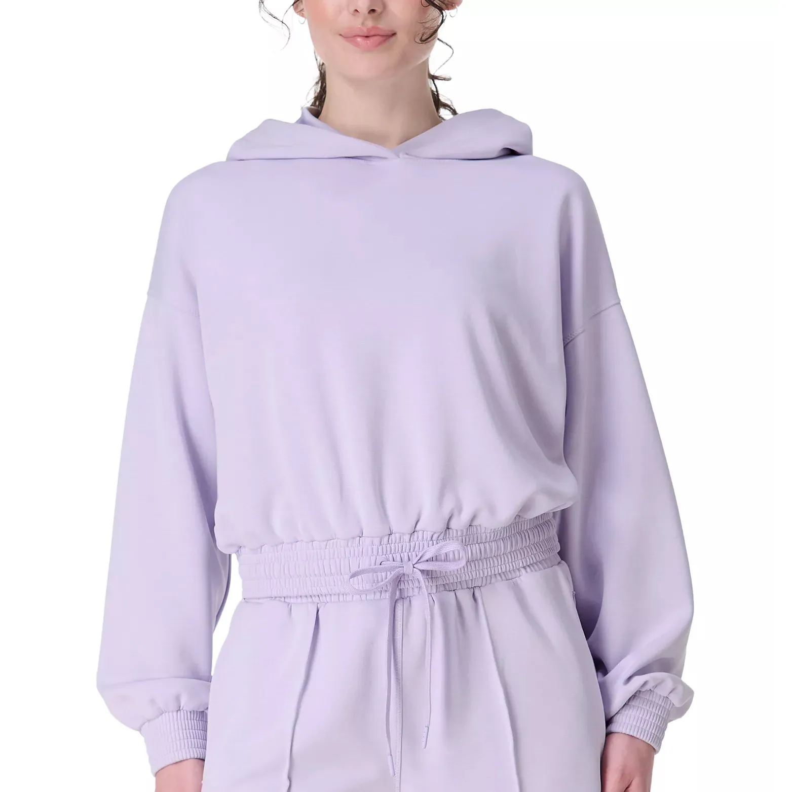 A woman is wearing a light purple hoodie with an elastic drawstring waist, paired with matching pants.