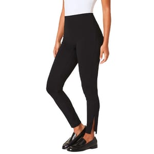 Black high-waisted leggings with a front slit at the ankles, paired with black loafers and a white top.