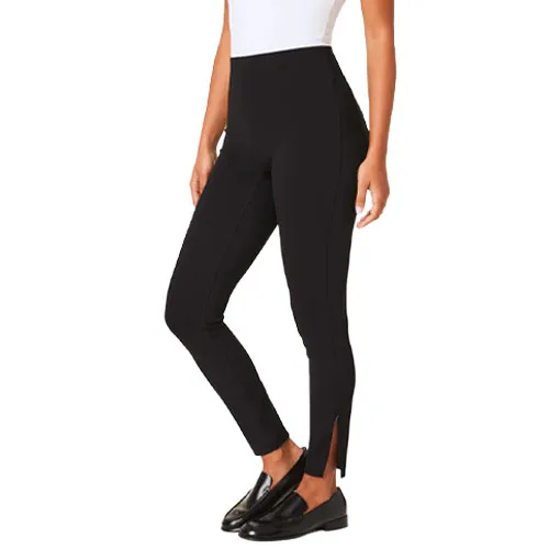 Black high-waisted leggings with a front slit at the ankles, paired with black loafers and a white top.