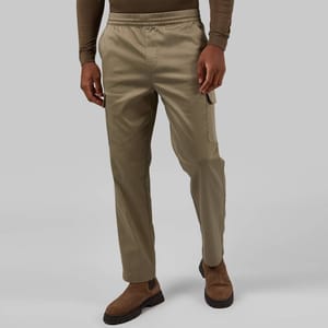 Khaki cargo pants with elastic waistband and cuffs, side cargo pockets, and visible seams, paired with brown suede shoes.