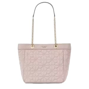 A quilted pink tote bag with chain and leather handles. The design features a subtle floral pattern, and the brand's logo is embossed near the top.