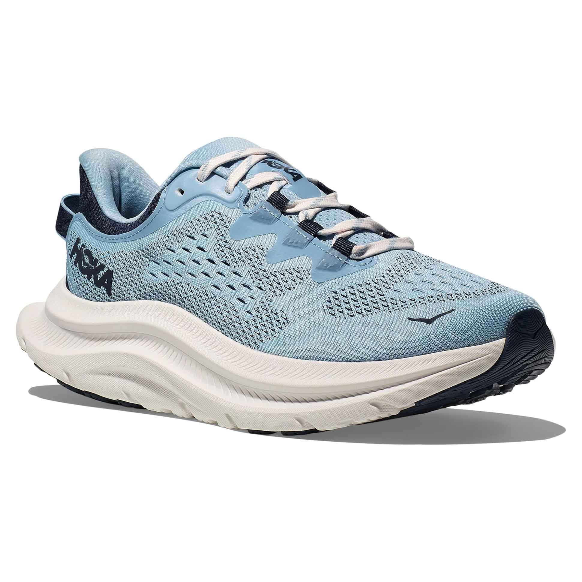 Hoka Women's Kawana 2 Shoes feature a light blue mesh upper with enhanced breathability, a cushioned midsole for comfort, and dark blue accents. The outsole is designed for traction and durability.