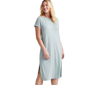 A woman wearing a light gray, short-sleeve midi sleep tee with a front pocket and side slits. The dress is casual and knee-length.