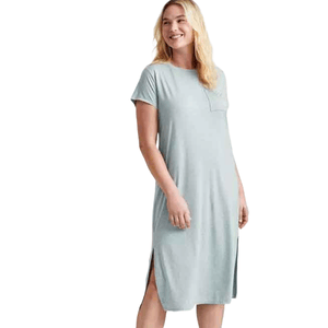 A woman wearing a light gray, short-sleeve midi sleep tee with a front pocket and side slits. The dress is casual and knee-length.