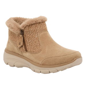 Tan ankle boot with a suede finish, faux fur lining, and a knit fabric upper section. It features a side zipper for easy entry and a cushioned rubber sole for comfort.
