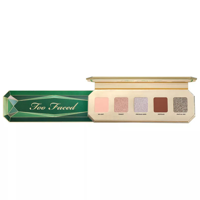 Too Faced Mini Eyeshadow Palette features five shades: No Limit (matte pink), Tsuki (shimmery rose gold), Precious Gems (sparkly lavender), Keepsake (matte brown), and Phase All Day (glittery silver). The packaging is green with a gem-like design.