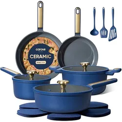Blue ceramic cookware set with two saucepans, two frying pans, gold handles, three blue utensils, and matching trivets.