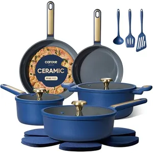 Blue ceramic cookware set with two saucepans, two frying pans, gold handles, three blue utensils, and matching trivets.