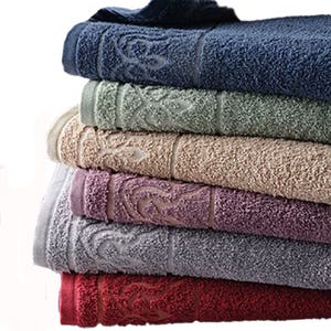 A stack of six folded, colorful towels featuring decorative patterns on their borders.