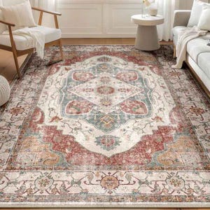 A 5' x 7' machine washable area rug with a distressed vintage design featuring a central medallion in red, teal, and cream hues, framed by intricate floral and geometric patterns on a beige background.