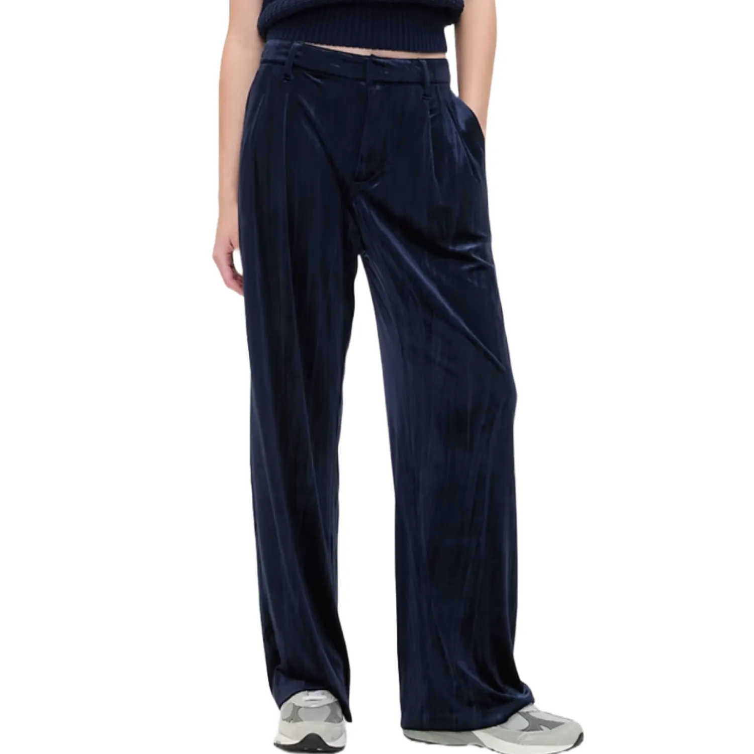 Navy blue velvet trousers with a wide-leg design, featuring a belted waist and side pockets, paired with casual sneakers.