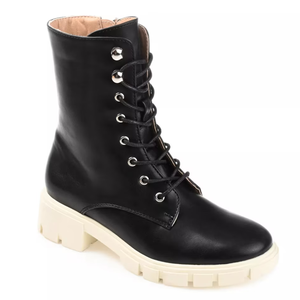 Black lace-up boot with a chunky white sole and a mid-calf height. Features metal eyelets and a textured platform for traction.