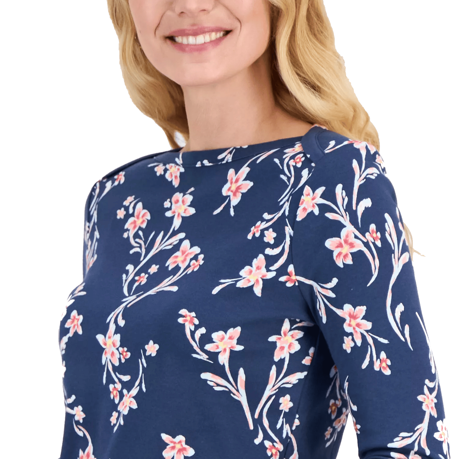 A woman wearing a navy blue top with a pink floral print, featuring long sleeves and a round neckline.