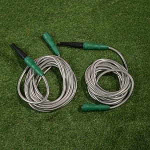 2pk Expanding Metal Hoses feature a durable stainless steel construction with green plastic connectors and black nozzles, neatly coiled on green grass.
