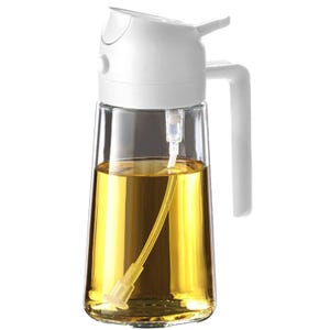 Clear oil dispenser with a white-capped spout and handle, containing yellow liquid.