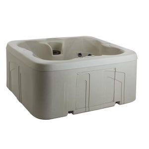 Square beige hot tub with seats and jets built into its interior.