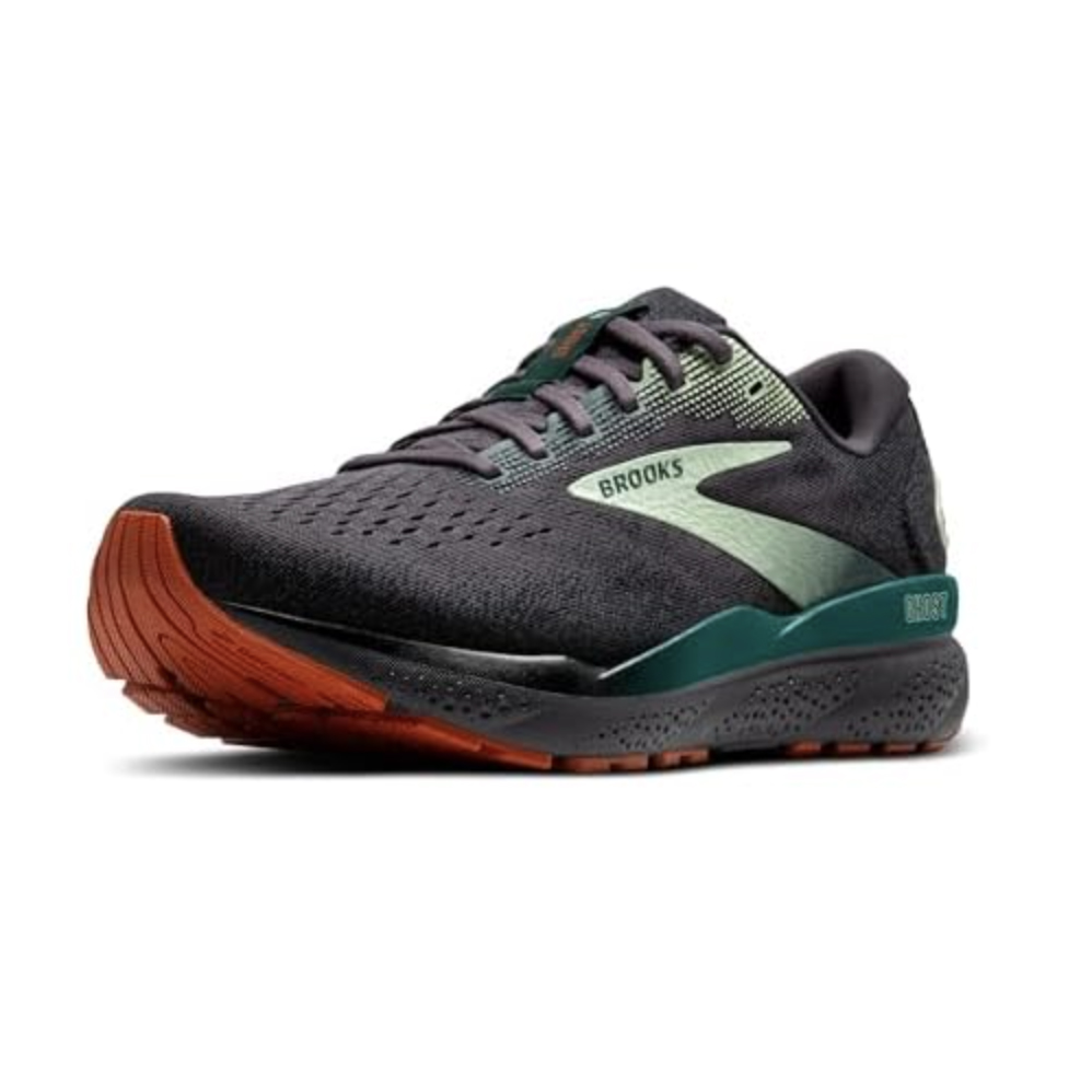 Brooks running shoe in dark gray with green accents and an orange sole, featuring the brand's logo on the side.