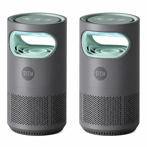 Two cylindrical air purifiers with a dark gray body and light green accents, featuring perforated designs near the base and an LED display on top.