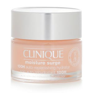 Clinique Moisture Surge 100H Auto-Replenishing Hydrator is a peach-colored skincare cream in a clear container with a silver lid, featuring aloe vera bio-ferment technology for long-lasting hydration.