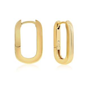 A pair of gold hoop earrings with a smooth, thick design.