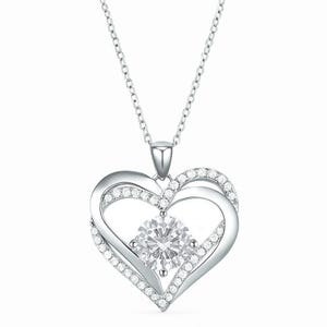 A heart-shaped pendant necklace with a dual-layered design, adorned with small diamonds and a larger central stone on a fine chain.