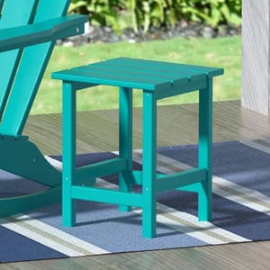 A turquoise Adirondack side table with a slatted top and sturdy rectangular legs, placed on an outdoor deck rug next to a chair.