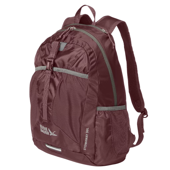 A burgundy Eddie Bauer Stowaway 30L backpack with multiple compartments, front buckle strap, and mesh side pockets.