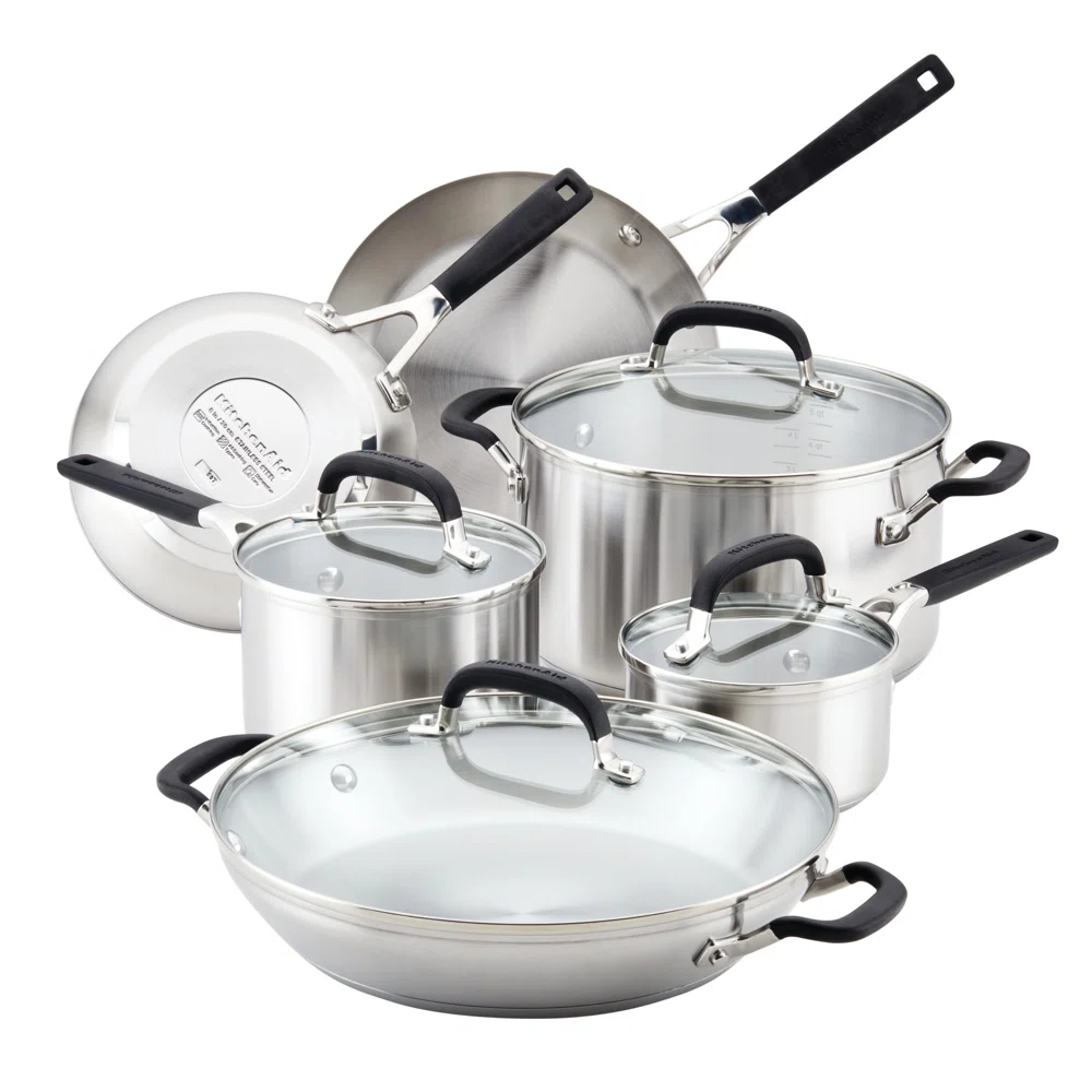 A set of stainless steel cookware, including pots, pans, and lids with black handles.