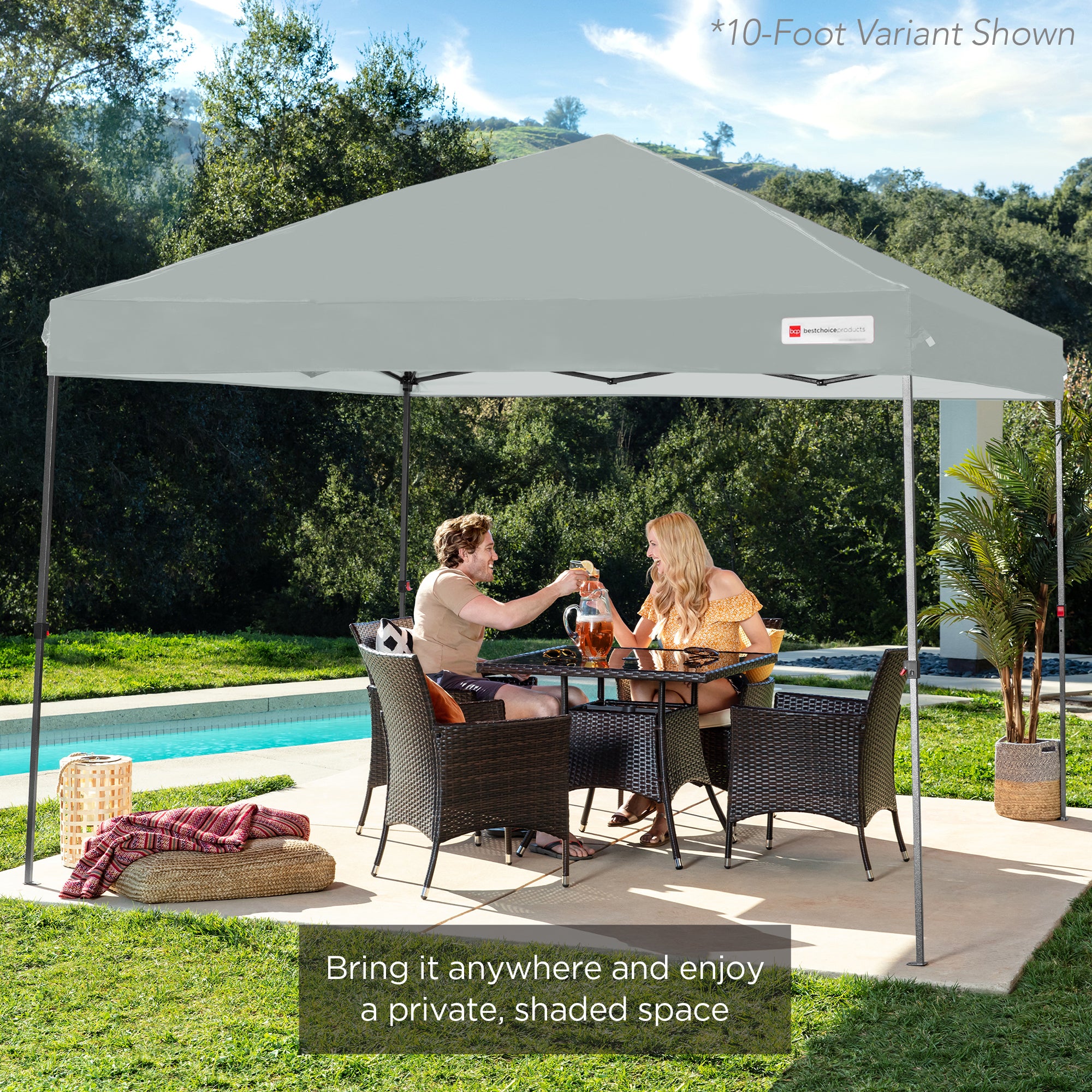 A 10-foot variant pop-up canopy providing shaded outdoor space for two people seated at a patio table.