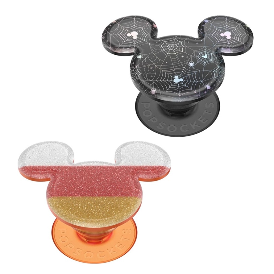 Two phone grips with iconic mouse ear designs, one themed with spiderwebs and stars, the other glittery with red and gold colors.