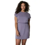 A woman is wearing a short-sleeve, lavender dress with a round neckline and elastic waistband.