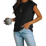A person wearing a sleeveless black top and light blue jeans holds a gray mug. A pendant necklace completes the casual outfit.