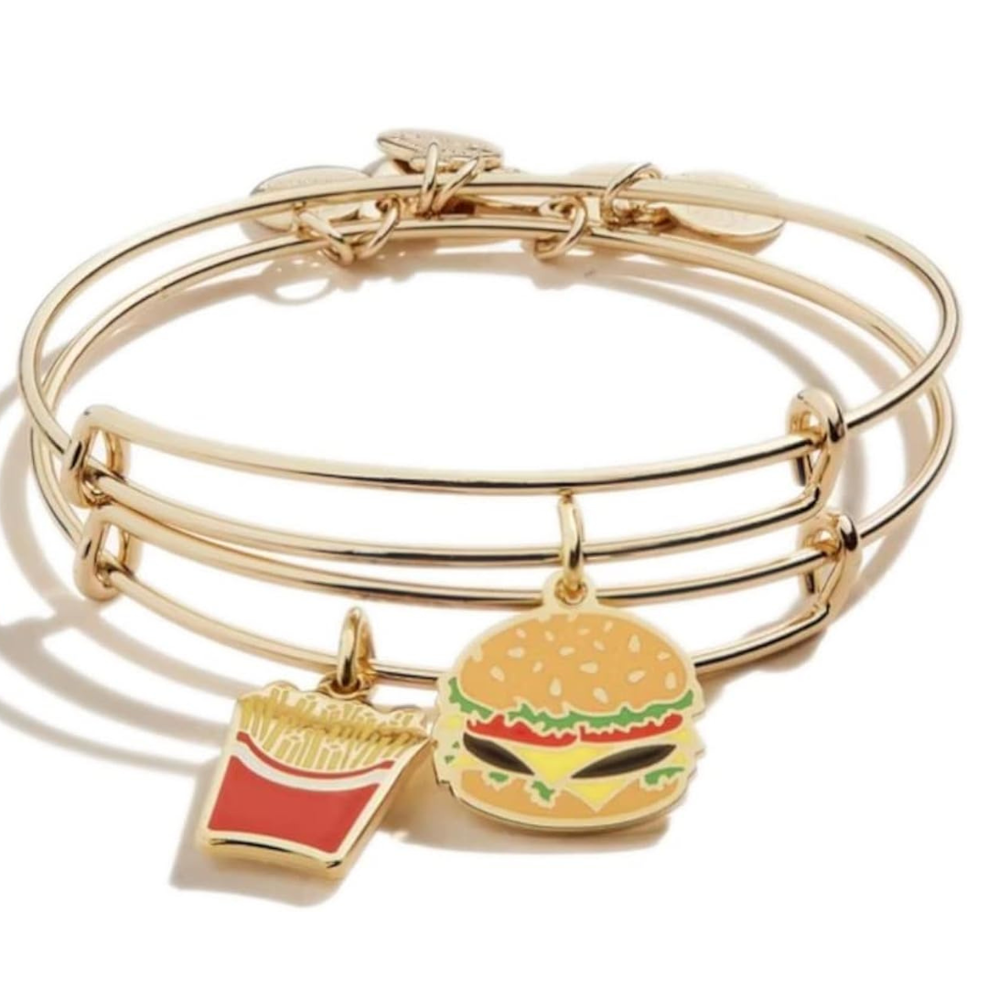 A gold-toned bangle with charms featuring a hamburger and a box of fries, designed to resemble popular fast food items.